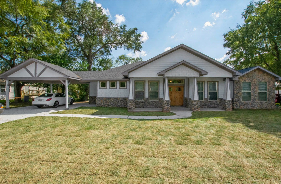 Completed Everline Homes craftsman ranch with stone accents and covered carport